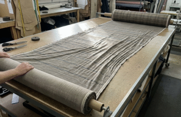 Fabric being rolled for relaxing machine to reduce fabric waste